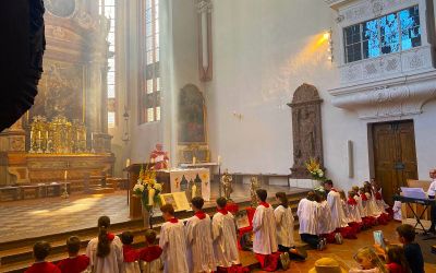 Ministranten knien vor dem Altar